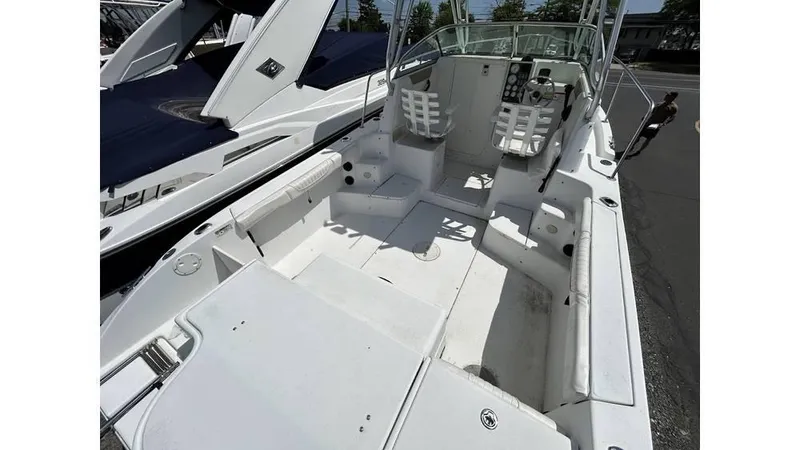 Slide: The Image of 2005 Seaswirl Striper 2301 Dual Console O/B boat interior, featuring spacious seating and helm. - 4