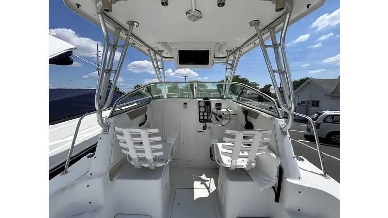 Slide: The Image of 2005 Seaswirl Striper 2301 Dual Console O/B boat interior with helm and seating. - 6