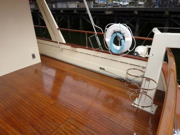 Slide: The Image of Wooden deck of a 1968 Monk 56 Flushdeck yacht with lifebuoy and railing. - 12