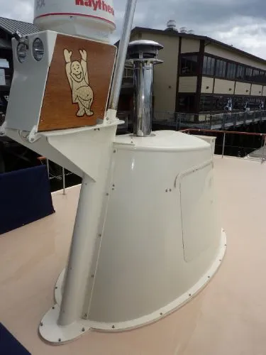Slide: The Image of 1968 Monk 56 Flushdeck boat detail with radar and playful wooden carving. - 16