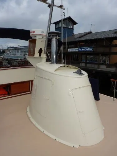 Slide: The Image of 1968 Monk 56 Flushdeck boat detail with nautical equipment, docked at a marina. - 17