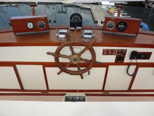 Slide: The Image of 1968 Monk 56 Flushdeck helm with wooden wheel and classic gauges. - 19