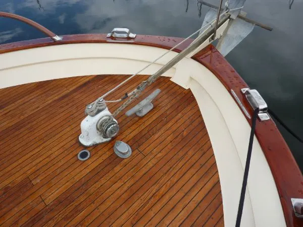 Slide: The Image of 1968 Monk 56 Flushdeck boat deck with wooden finish and anchor mechanism. - 24