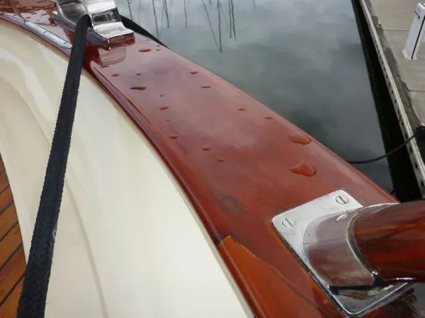 Slide: The Image of Polished wooden deck of 1968 Monk 56 Flushdeck boat with water droplets. - 25