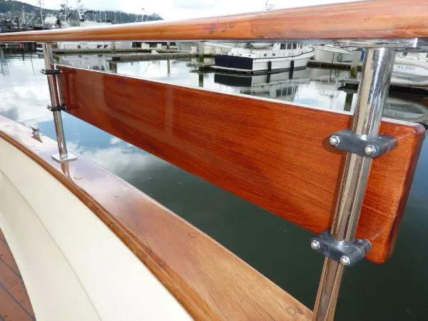 Slide: The Image of Polished wooden railing on 1968 Monk 56 Flushdeck yacht, docked at marina. - 27