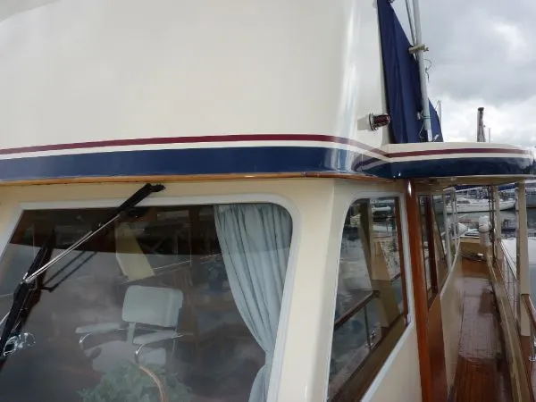 Slide: The Image of 1968 Monk 56 Flushdeck yacht with wooden trim and blue-striped exterior. - 29