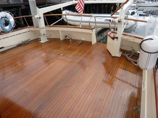Slide: The Image of 1968 Monk 56 Flushdeck yacht with polished wooden deck and American flag. - 31