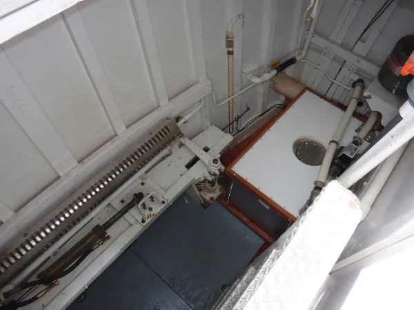Slide: The Image of Engine room of 1968 Monk 56 Flushdeck boat, showcasing mechanical components and piping. - 34