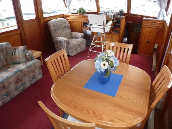 Slide: The Image of Interior of 1968 Monk 56 Flushdeck yacht with dining table and floral centerpiece. - 39