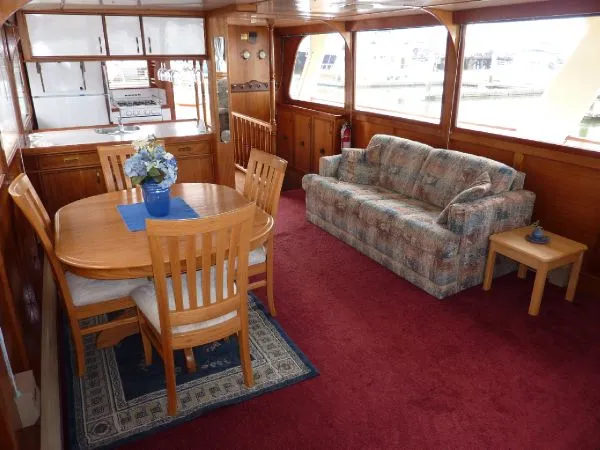 Slide: The Image of Interior of 1968 Monk 56 Flushdeck yacht with dining area and sofa. - 40
