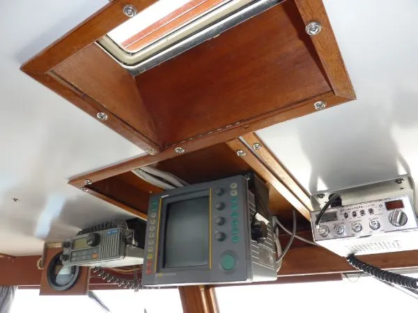 Slide: The Image of 1968 Monk 56 Flushdeck boat interior with vintage navigation equipment and wooden paneling. - 42