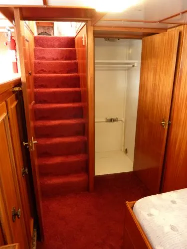 Slide: The Image of Interior of 1968 Monk 56 Flushdeck yacht with red carpeted stairs and wooden cabinetry. - 45