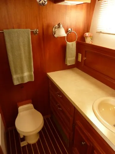 Slide: The Image of 1968 Monk 56 Flushdeck yacht bathroom with wood paneling, sink, and toilet. - 47