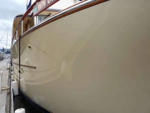 Slide: The Image of 1968 Monk 56 Flushdeck yacht docked, showcasing sleek, polished hull design. - 5