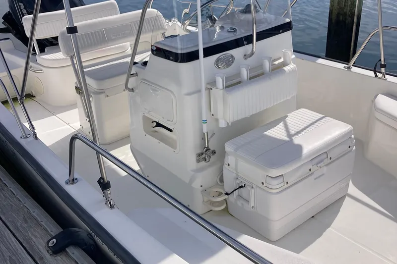 Slide: The Image of 2011 Boston Whaler 190 Montauk boat interior with seating and storage. - 14