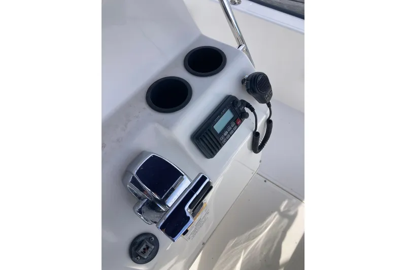 Slide: The Image of Control panel of a 2011 Boston Whaler 190 Montauk boat with radio and cup holders. - 16