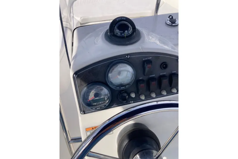 Slide: The Image of Control panel of a 2011 Boston Whaler 190 Montauk boat with gauges and switches. - 18