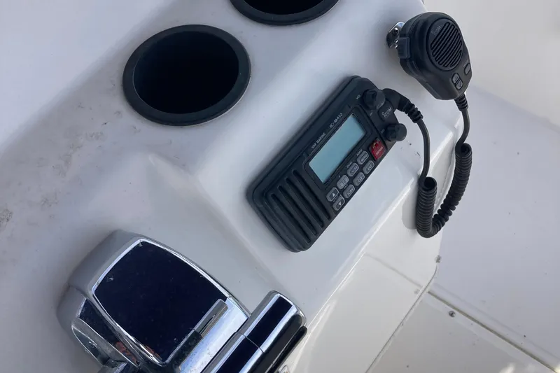 Slide: The Image of Control panel of a 2011 Boston Whaler 190 Montauk with radio and cup holders. - 6
