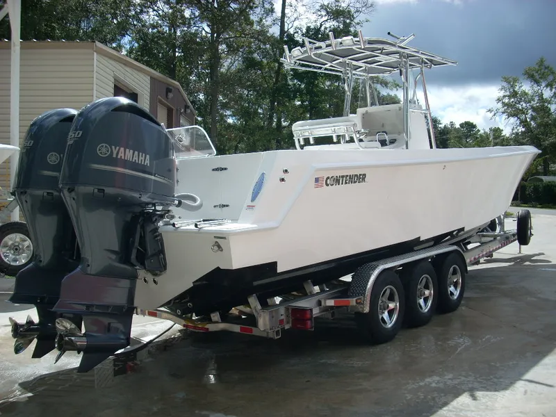 Slide: The Image of 2024 Contender 35 ST STEP HULL boat with twin Yamaha engines on trailer. - 3