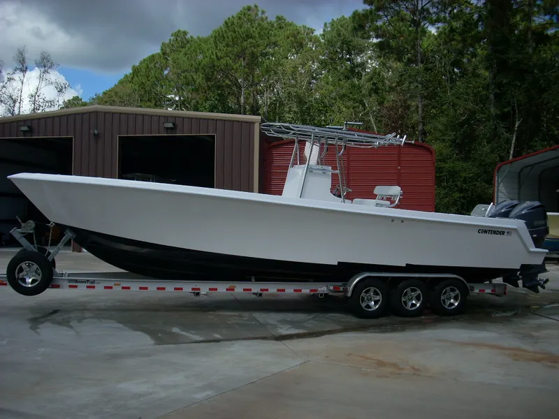Slide: The Image of 2024 Contender 35 ST STEP HULL boat on a trailer in front of storage units. - 4