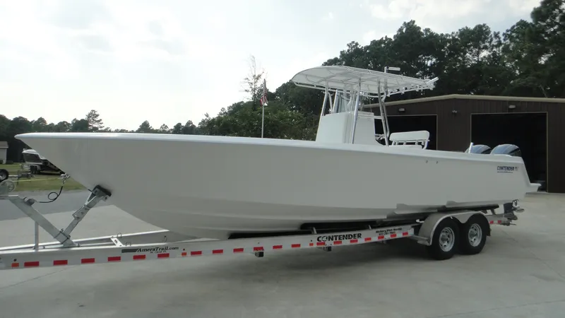 The Image of 2024 Contender 32 ST boat on trailer, parked outdoors. - 1