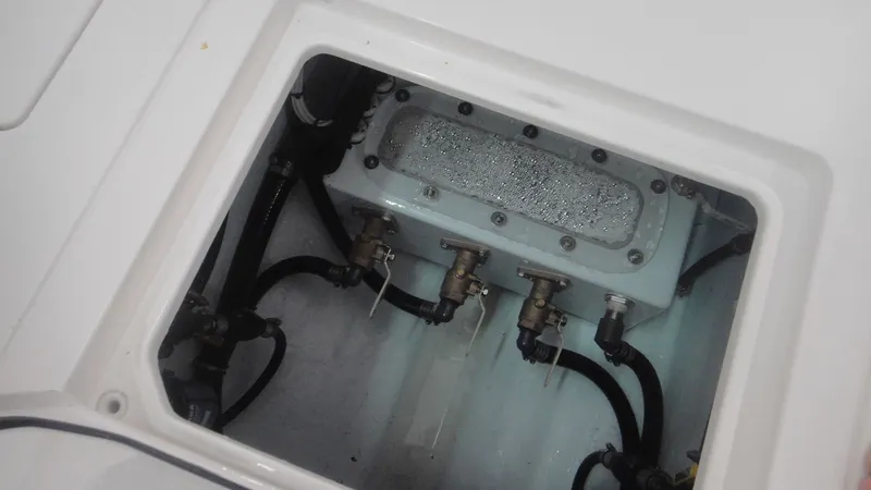 Slide: The Image of 2024 Contender 32 ST boat engine compartment with hoses and fittings. - 17