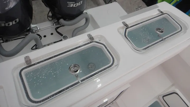 Slide: The Image of 2024 Contender 32 ST boat with dual Yamaha 300 engines and livewell compartments. - 19