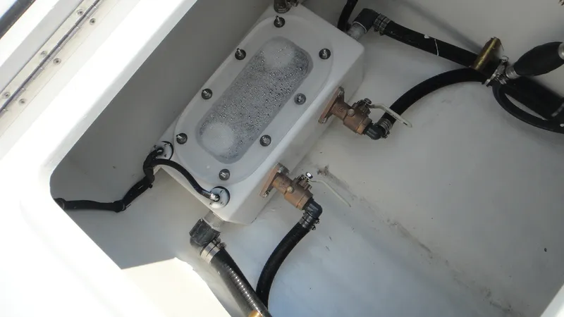 Slide: The Image of 2024 Contender 32 ST boat plumbing system with valves and hoses. - 4