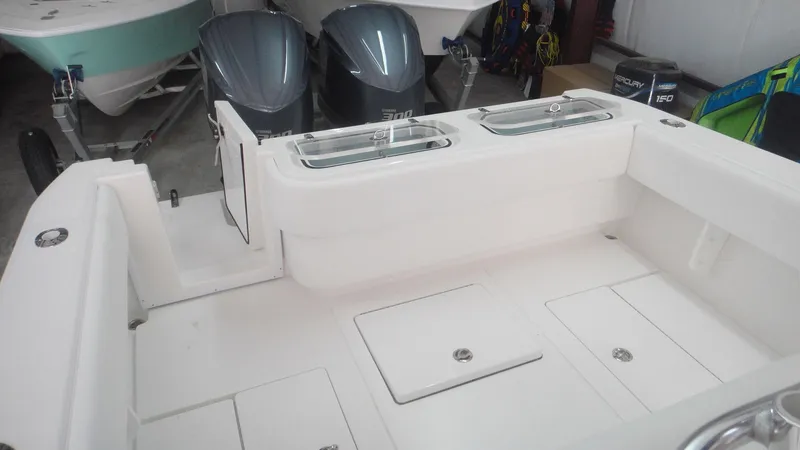 Slide: The Image of 2024 Contender 32 ST boat with dual outboard engines in a showroom. - 6