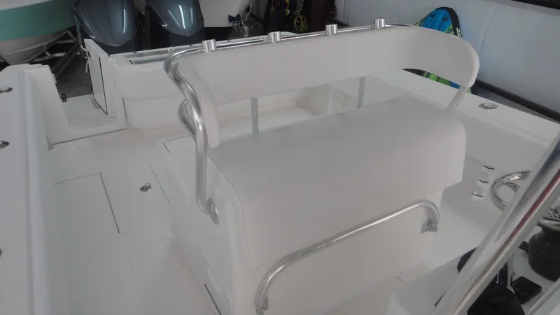 Slide: The Image of 2024 Contender 32 ST boat interior with white seating and stainless steel railings. - 7