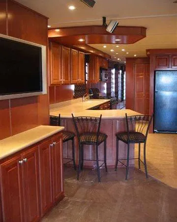 Slide: The Image of Luxurious kitchen interior in a 2006 Sharpe Makena Share 5 houseboat with wood cabinetry. - 11