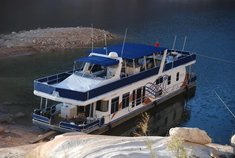 Slide: The Image of Houseboat on calm water, Sharpe Makena Share 5, 2006 model, with blue and white design. - 13