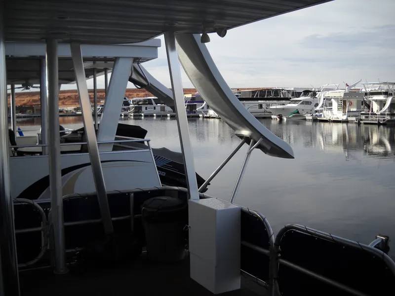 Slide: The Image of Houseboats docked at a marina, featuring a 2006 Sharpe Makena Share 5. - 6