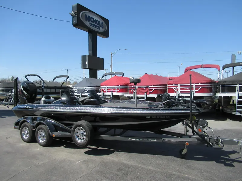 Slide: The Image of 2012 Ranger Z-521 DC boat on trailer at dealership, clear sky background. - 0