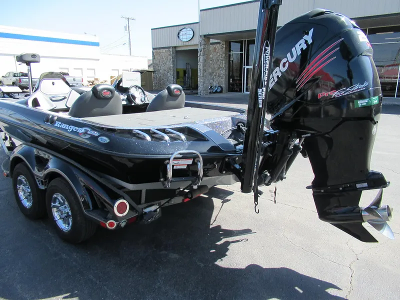 Slide: The Image of 2012 Ranger Z-521 DC boat with Mercury engine, parked outside a building. - 5