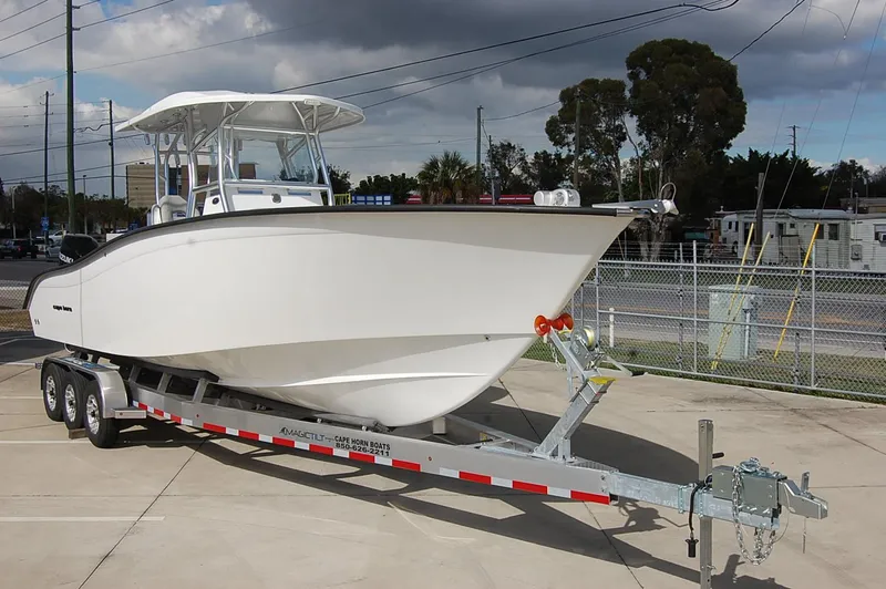 Slide: The Image of 2023 Cape Horn 31T boat on a trailer in a parking lot. - 2
