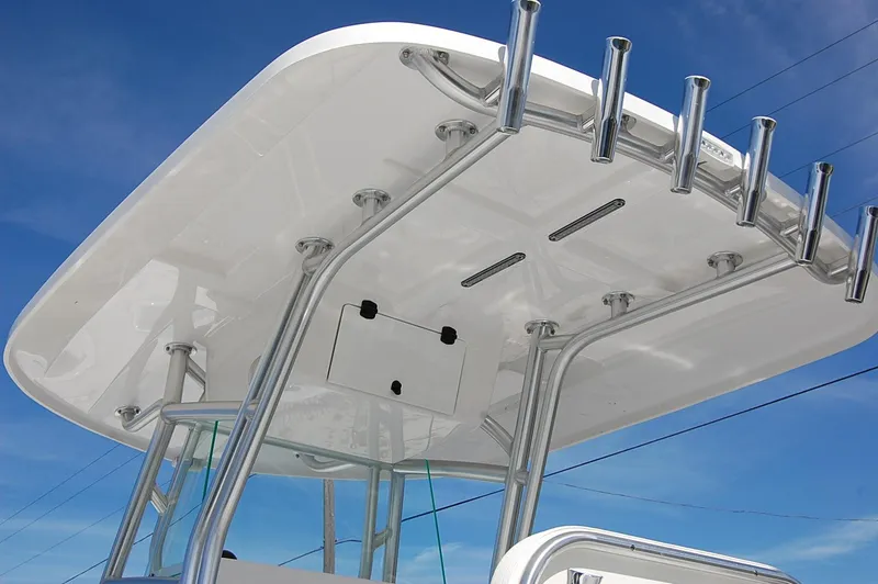 Slide: The Image of 2025 Cape Horn 27 XS boat T-top with rod holders against blue sky. - 12
