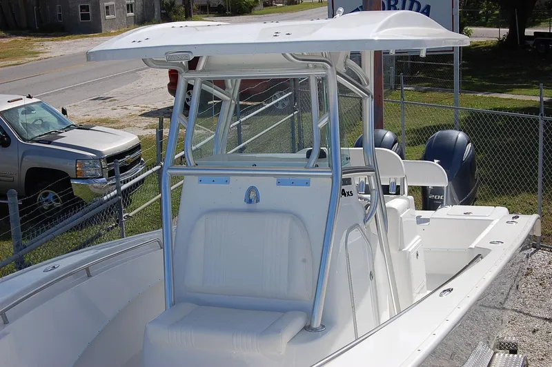 Slide: The Image of 2025 Cape Horn 27 XS boat with T-top and dual outboard engines. - 11