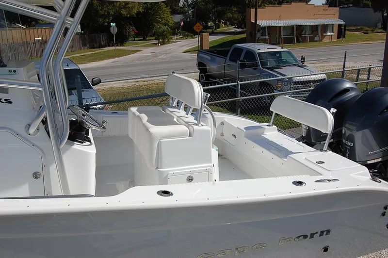 Slide: The Image of 2025 Cape Horn 27 XS boat with dual outboard motors and white seating. - 9