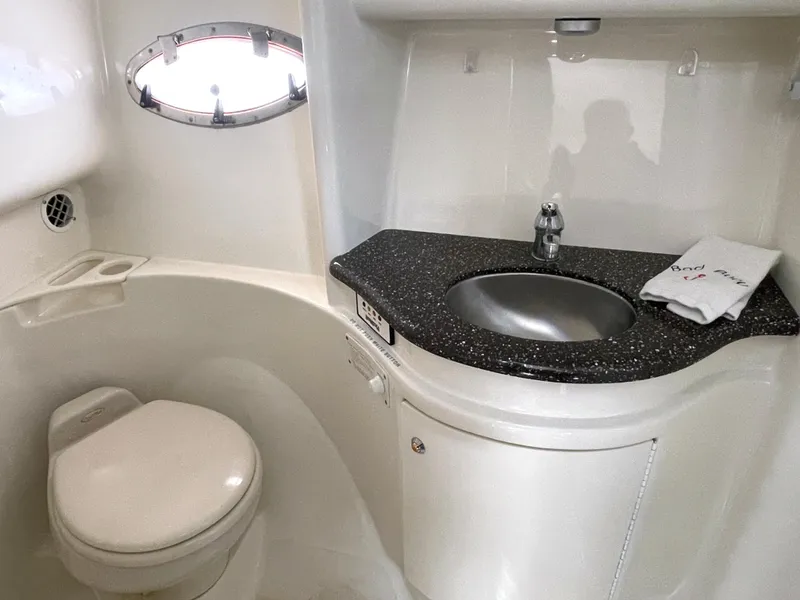 Slide: The Image of 2004 Formula 37 PC yacht bathroom with sink, toilet, and porthole window. - 13