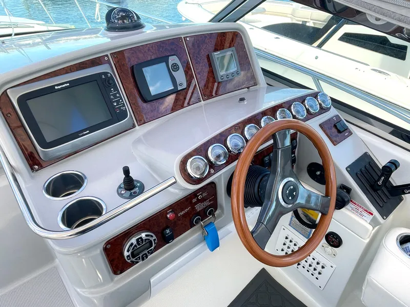 Slide: The Image of 2004 Formula 37 PC boat dashboard with steering wheel and navigation instruments. - 3
