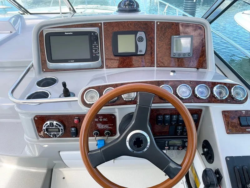 Slide: The Image of 2004 Formula 37 PC yacht dashboard with wood accents and modern navigation equipment. - 4