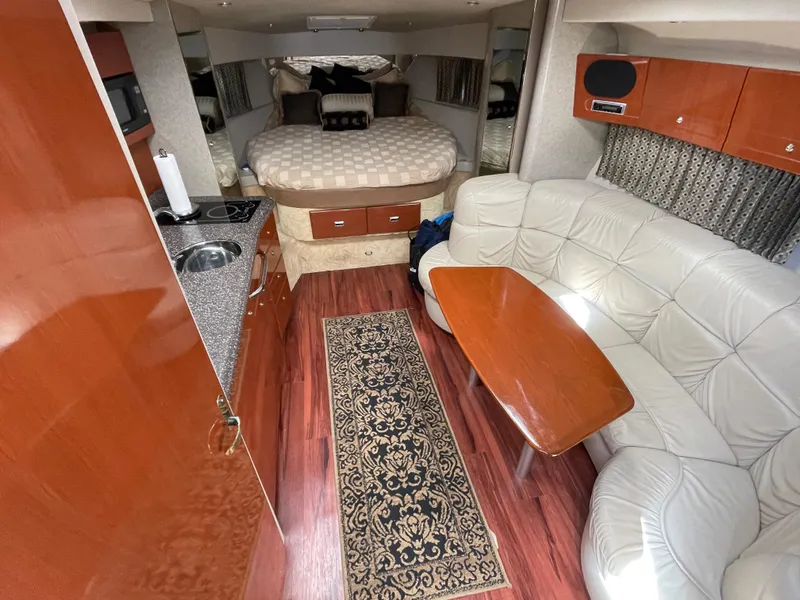 Slide: The Image of Luxurious interior of a 2004 Formula 37 PC yacht with kitchen, seating, and bed. - 5
