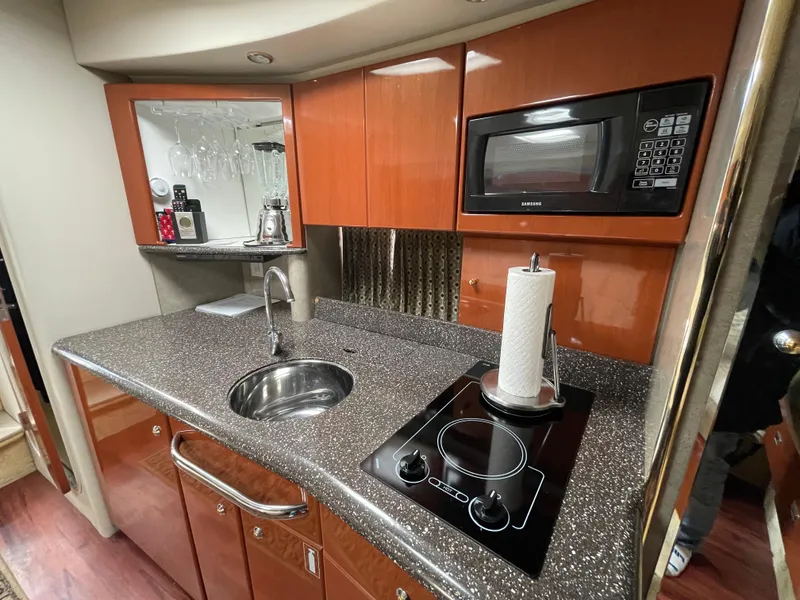 Slide: The Image of 2004 Formula 37 PC yacht kitchen with microwave, stovetop, and sink. - 9