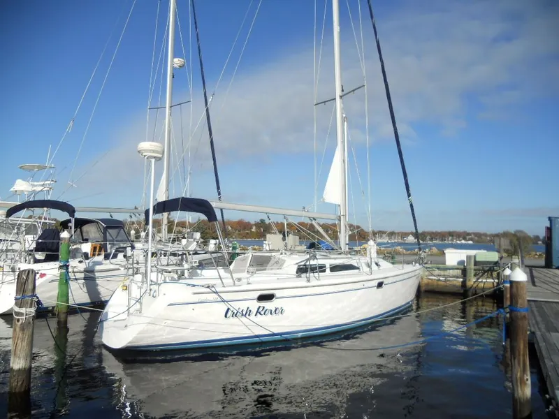 The Image of 1999 Catalina 320 sailboat docked in a marina. - 0