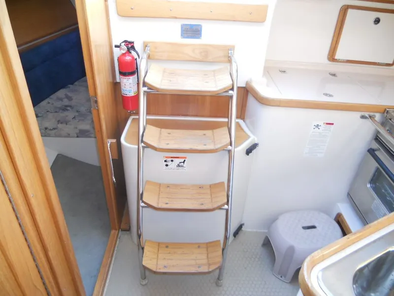 Slide: The Image of Interior of a 1999 Catalina 320 yacht with wooden steps. - 15