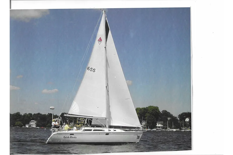Slide: The Image of Sailing yacht Catalina 320, 1999 model, gliding on a sunny day with clear skies. - 4