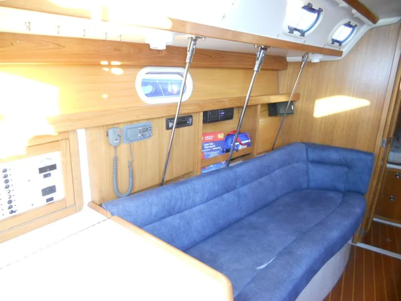 Slide: The Image of Interior of a 1999 Catalina 320 yacht with blue upholstery. - 9