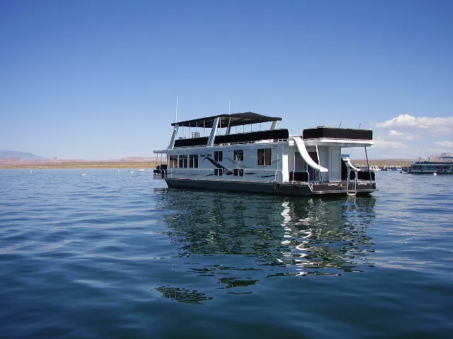 The Image of 2005 Starlite Multi Owner Houseboat on calm water under clear blue sky. - 1