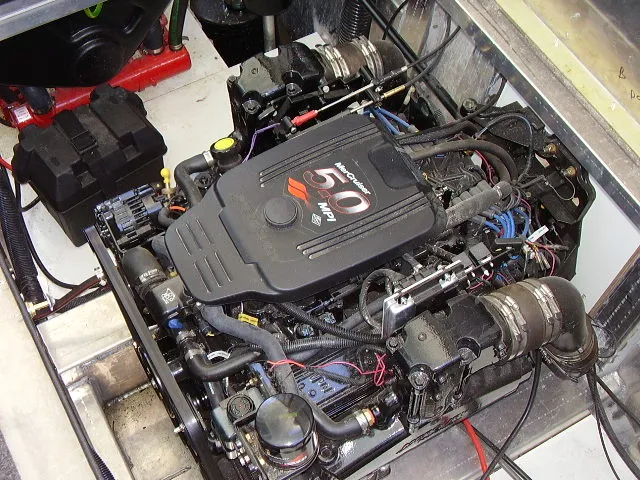 Slide: The Image of Engine compartment of a 2005 Starlite Multi Owner Houseboat, featuring a powerful 5.0 MPI motor. - 11